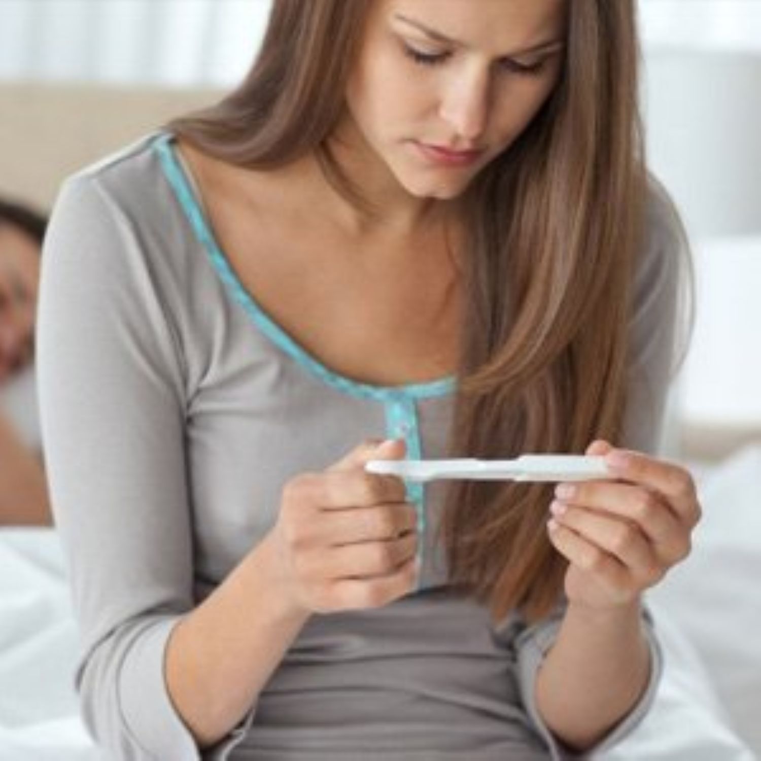 woman looking at pregnancy test